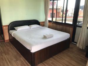 a bed in a room with a large window at Hotel Mandala in Kathmandu