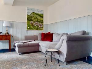 a living room with a couch and a table at Charming holiday home with natural garden in Kaltennordheim Thuringia in Unterweid