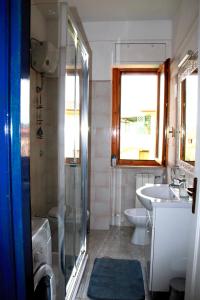a bathroom with a shower and a sink and a toilet at Casa Serendipity Sabaudia in Sabaudia