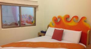 Postel nebo postele na pokoji v ubytování Kenting Sun & Sea B&B