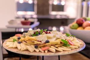 a plate of pasta and vegetables on a table at NAU Sao Rafael Suites - All Inclusive in Albufeira