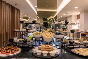 a buffet with many different types of food on display at NAU Sao Rafael Suites - All Inclusive in Albufeira