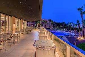 a hotel patio with tables and chairs and a swimming pool at NAU Sao Rafael Suites - All Inclusive in Albufeira