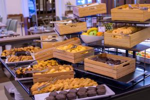 a buffet with boxes of different types of food at NAU Sao Rafael Suites - All Inclusive in Albufeira