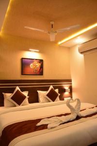 a hotel room with a bed with a towel on it at Hotel Moody Moon budget friendly stay near igi international airport delhi in New Delhi