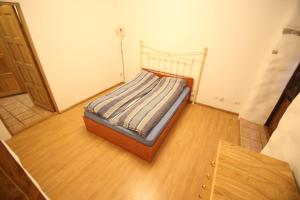 a small bed in a room with a wooden floor at Viru Old Town Apartment in Tallinn +12 photos