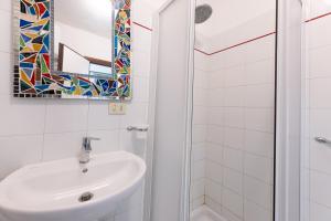 a bathroom with a sink and a mirror at Villino Straccoligno - Goelba in Capoliveri