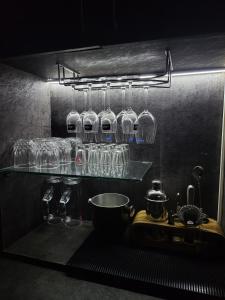 a kitchen with glasses on a shelf and a sink at The Havelock Hotel, Vijay Nagar in Indore +30 photos