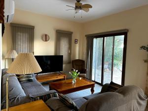 a living room with two couches and a tv at Seaview Villa Daria in Neokhorio