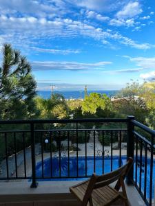 a balcony with a view of a swimming pool at Seaview Villa Daria in Neo Chorio