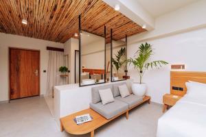 a living room with a couch and a bed at Samawa Living in Paje
