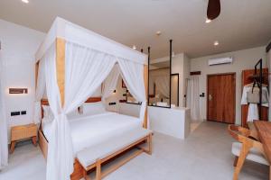 a bedroom with a bed with a canopy at Samawa Living in Paje