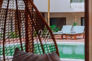 a view of a swimming pool with two chairs and an umbrella at Samawa Living in Paje