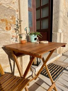 a wooden picnic table sitting next to a building at Spacious Apartment in Vabriga