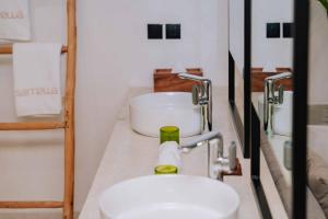a bathroom with a sink and a toilet on a counter at Samawa Living in Paje