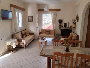 a living room with a couch and a table at Lina's House Pramanta in Pramanta