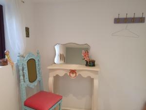 a dressing room with a mirror and a red stool at Bayview Bed & Breakfast in Béal an dá Chab
