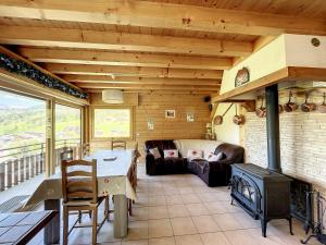 a living room with a table and a fireplace at Chalet Les Hotelieres - 8 pers - Proche des pistes in Les Gets