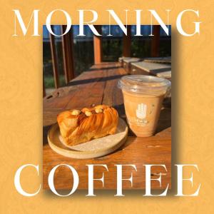 a table with a plate of croissant and a cup of coffee at Khaokhai Cafe & Resort in Khao Kho