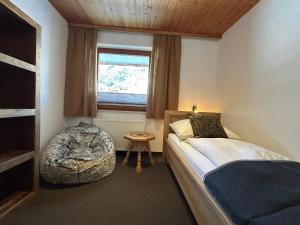 a small bedroom with a bed and a window at Chalet 1480 in Gaschurn