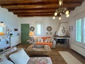 a living room with a couch and a table at Beachfront House Kipri in Kipri