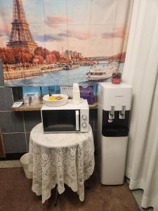 a microwave on a table with a picture of the eiffel tower at Stay Mido in Busan
