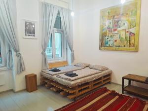 a bedroom with a bed in the corner of a room at Par Par Apartman in Budapest