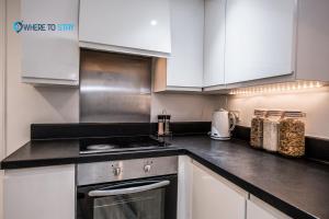 a kitchen with white cabinets and a stove top oven at Wheretostay 1 bed apartment Aberdeen in Aberdeen