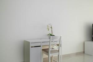 a white desk with a chair and a white wall at Lux BnB I AG Tower I Canal Views in Dubai