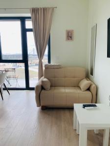a living room with a couch and a table at Belgrade Waterfront - Beograd na vodi - BG011 in Belgrade