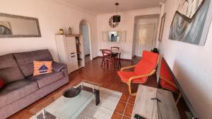 a living room with a couch and a table at Vera Playa Naturista, Mar y Sol in Vera