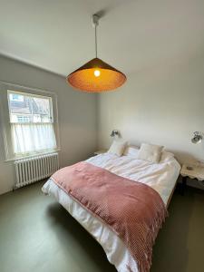 a bedroom with a large bed with a red blanket at Beautifully Designed 4BD House Peckham London! in London