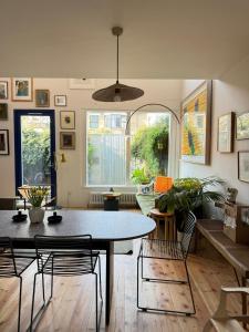 a living room with a table and chairs at Beautifully Designed 4BD House Peckham London! in London