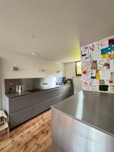 a kitchen with a stainless steel counter in a kitchen at Beautifully Designed 4BD House Peckham London! in London