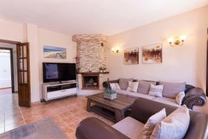 a living room with a couch and a fireplace at Large townhouse Marbella golden mile in Marbella