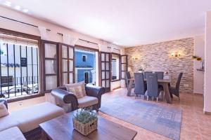 a living room with a table and a dining room at Large townhouse Marbella golden mile in Marbella