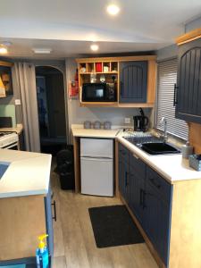 an rv kitchen with a sink and a microwave at THE VAN in Porchfield