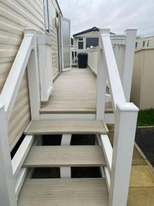a wooden staircase leading up to a house at 8 Berth Caravan At The Seaside Of Haven Hopton-on-sea In Norfolk Ref 80065f in Great Yarmouth