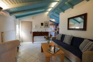 a living room with a couch and a table at Anemomilos Sea View Penthouse in Corfu Town