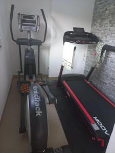 a gym with a treadmill and a tread machine at Casa Estrela in Alvaiázere