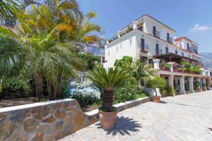 a building with a palm tree in front of it at Large townhouse Marbella golden mile in Marbella