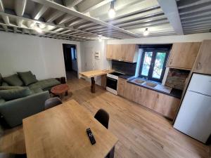 a kitchen and living room with a table and a couch at Danai Traditional Apartment in Samos