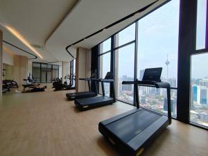 a gym with a bunch of treadmills in a building at Axon Bukit Bintang_Studio (B) in Kuala Lumpur