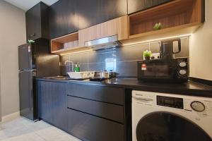 a kitchen with a microwave and a dishwasher at Axon Bukit Bintang_Studio (B) in Kuala Lumpur
