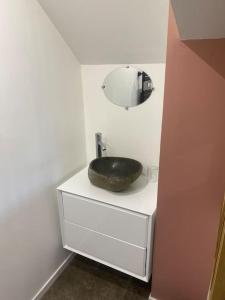 a bathroom with a black sink and a mirror at « La Suisse » Courcelloise in Courcelles-Sapicourt