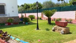 a park with a bench and a light pole at 3 bedrooms villa with private pool enclosed garden and wifi at Valencia in Marchuquera
