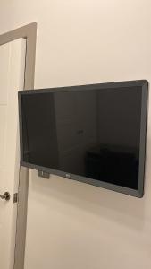 a flat screen tv hanging on a wall at nana house in London