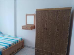 A bed or beds in a room at Anglo Chalets - Ageeba beach