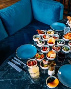 a table with blue plates and bowls of food at N9 Hotels in Nürnberg