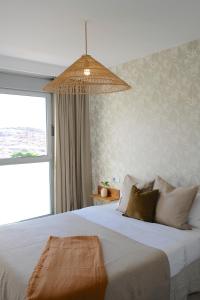 a bedroom with a large bed with a large window at Casa Mara Médano in El Médano +53 photos
